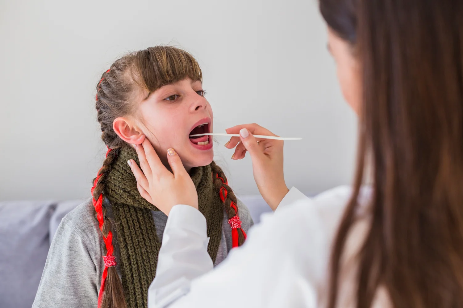 A speech therapist guiding a child through oral-motor exercises to improve speech clarity and muscle coordination